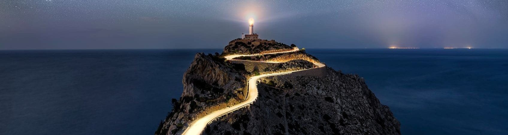 A light house on top of a mountain with lights