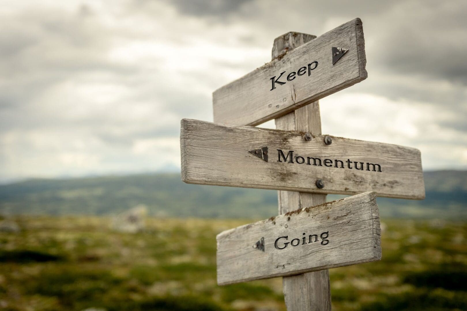 Wooden sign with "Keep Momentum Going.