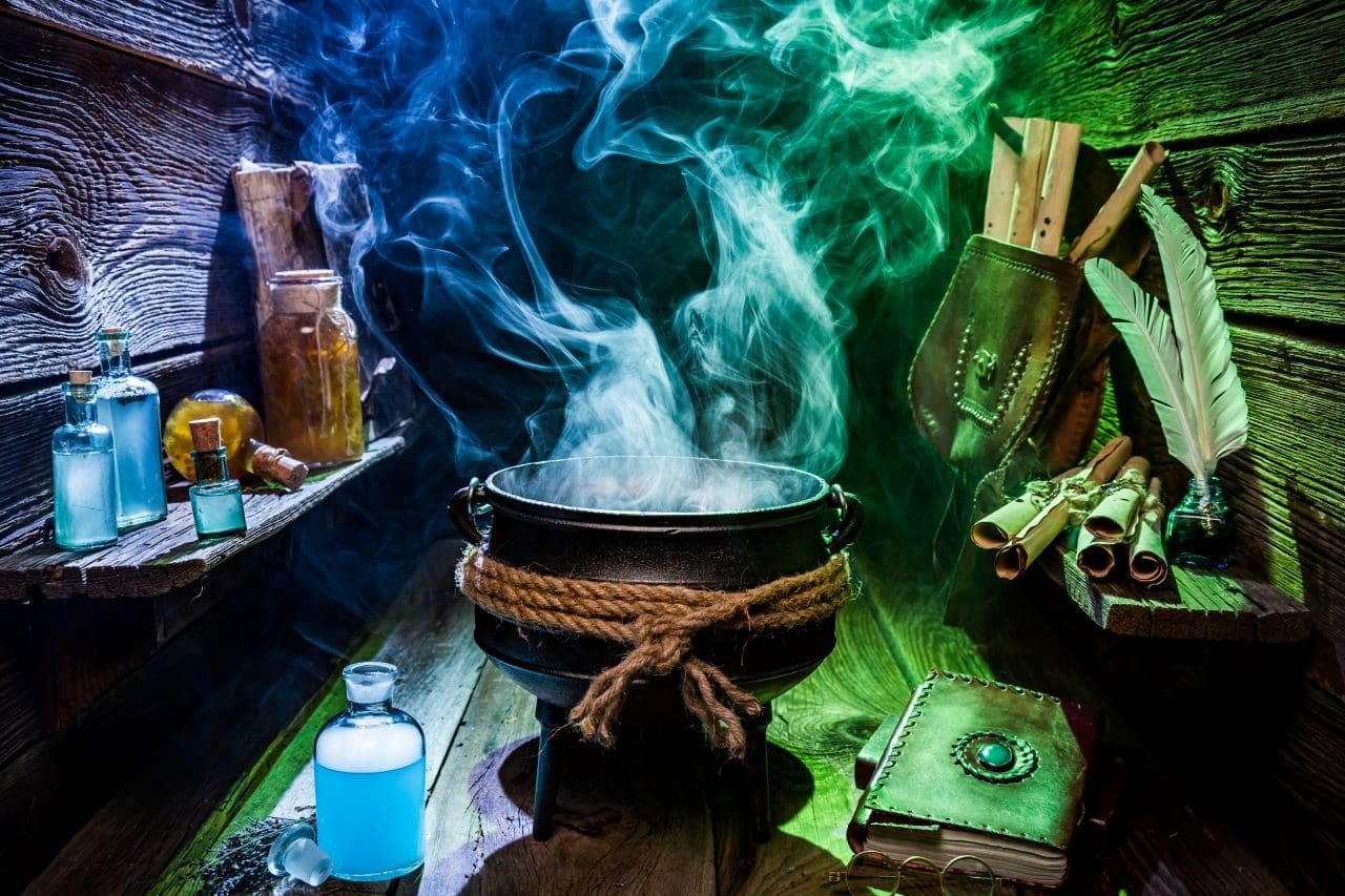 Mystical cauldron with potions and scrolls.